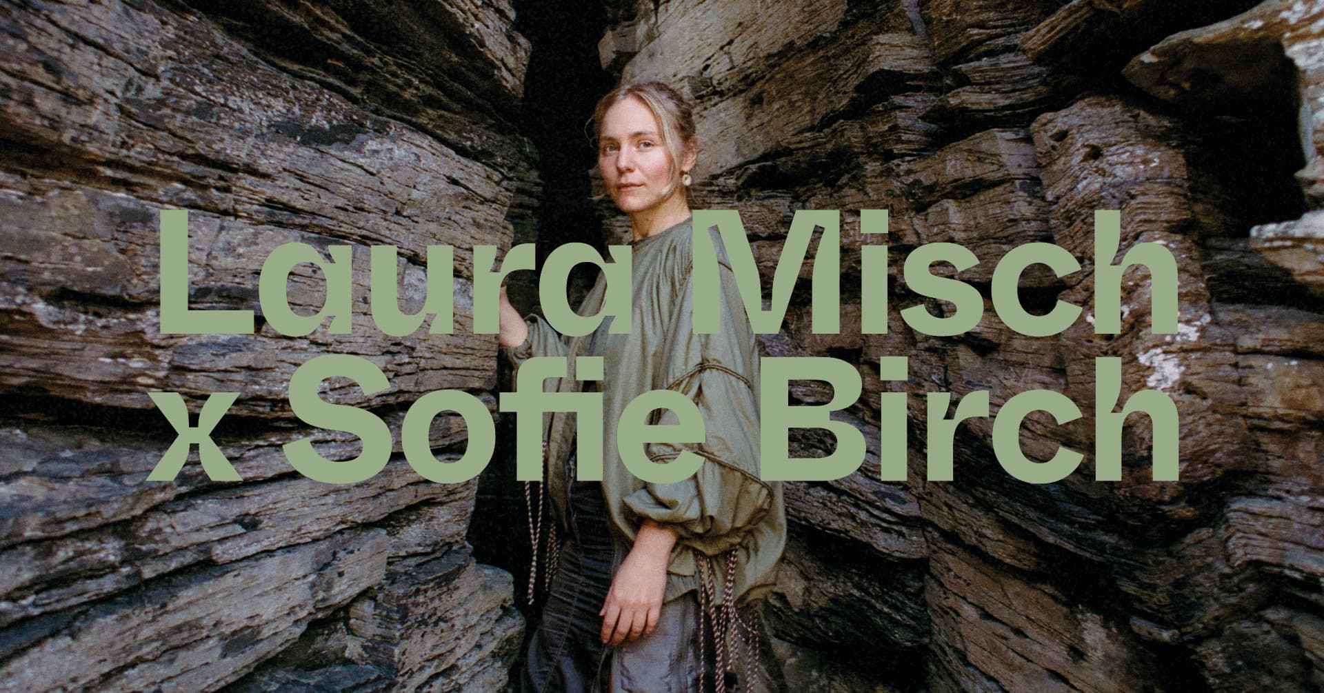 A woman stands between rock formations, with the text "Laura Misch x Sofie Birch" overlaid.