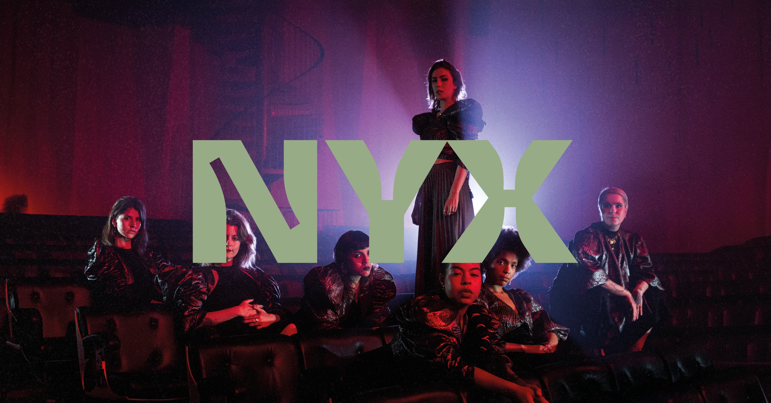 A group of people in dramatic lighting with the word "NYX" in large text across the center.